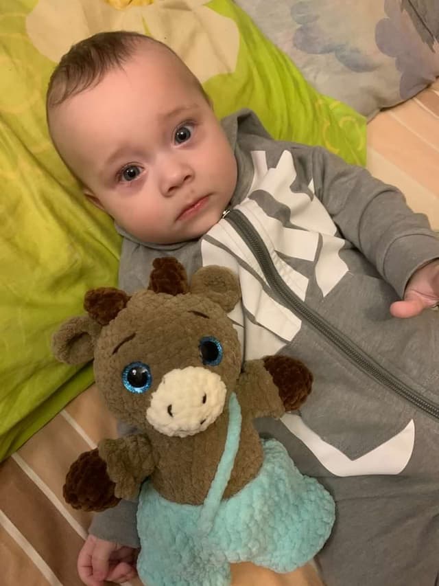 Baby sleeping with a handmade crochet deer