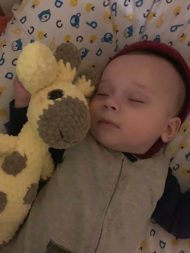 Baby sleeping with a handmade giraffe
