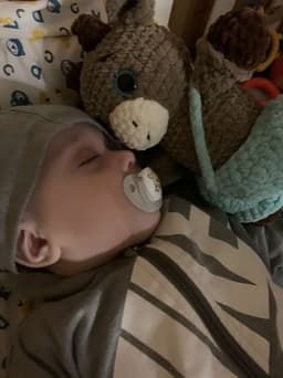 Baby sleeping with a handmade crochet friend