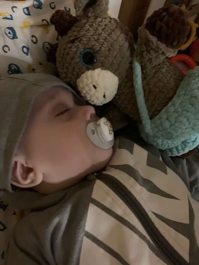Baby sleeping with a handmade crochet friend