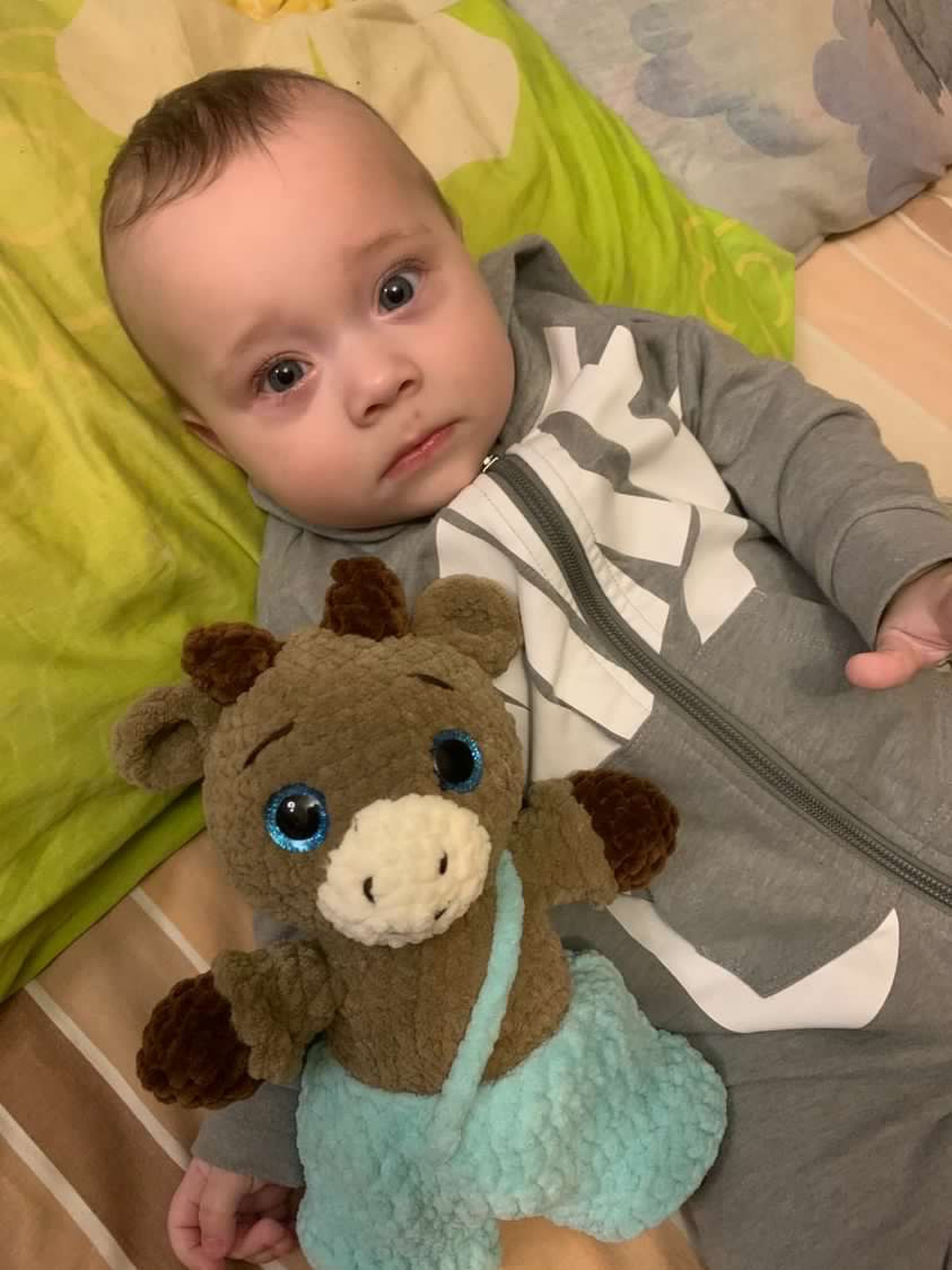 Baby sleeping peacefully with a handmade crochet deer