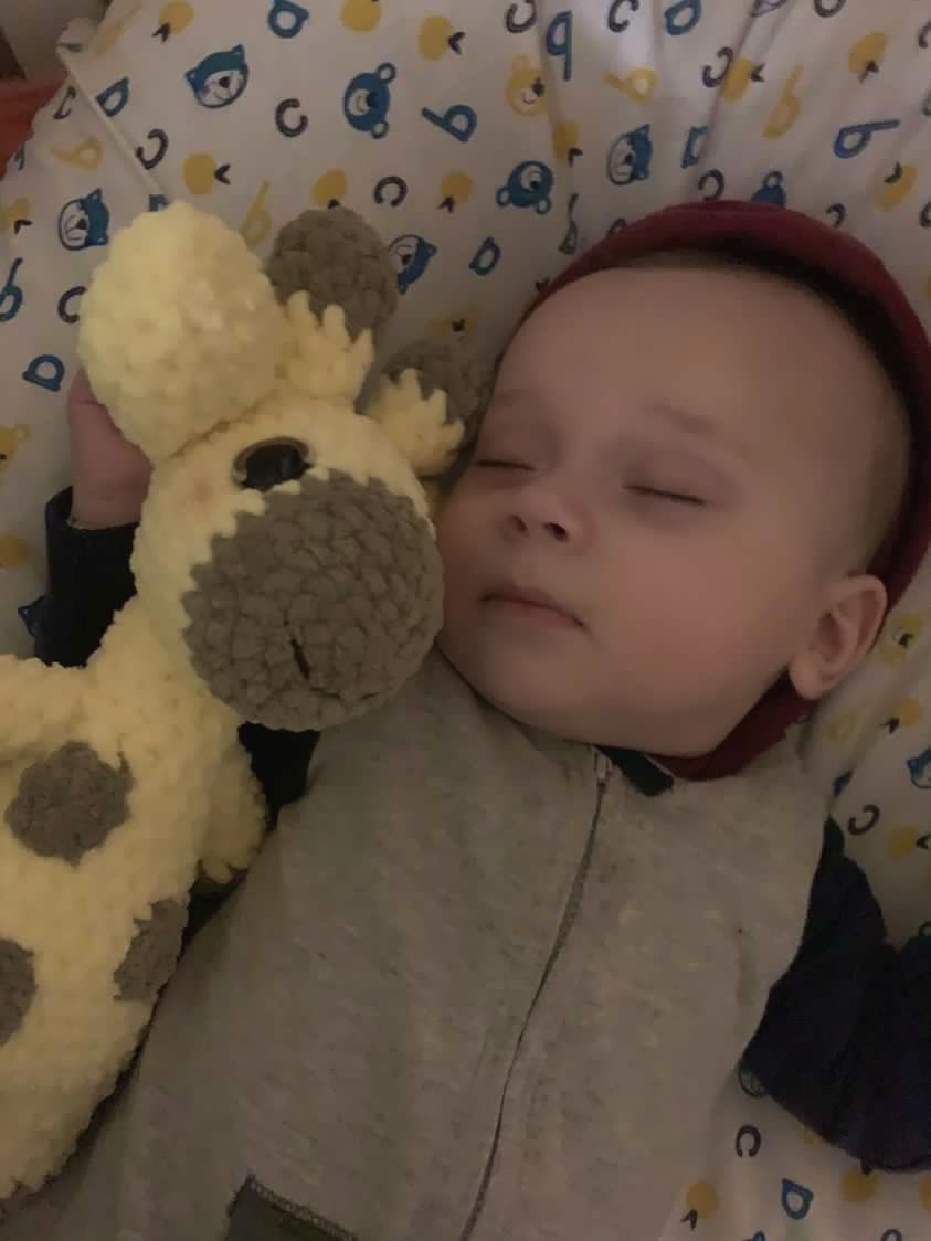 Baby sleeping with a handmade giraffe